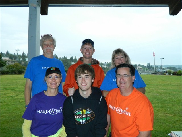 Jared (center) with his family and Make-A-Wish volunteers