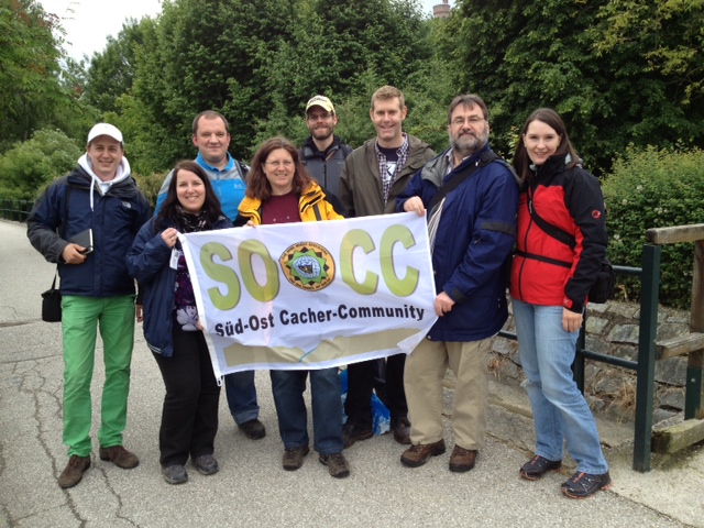 A group of geocachers attending the Mega-Event with a well-traveled banner (Eric is the third from the right)