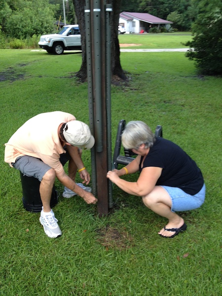 Two geocachers working to figure this one out.