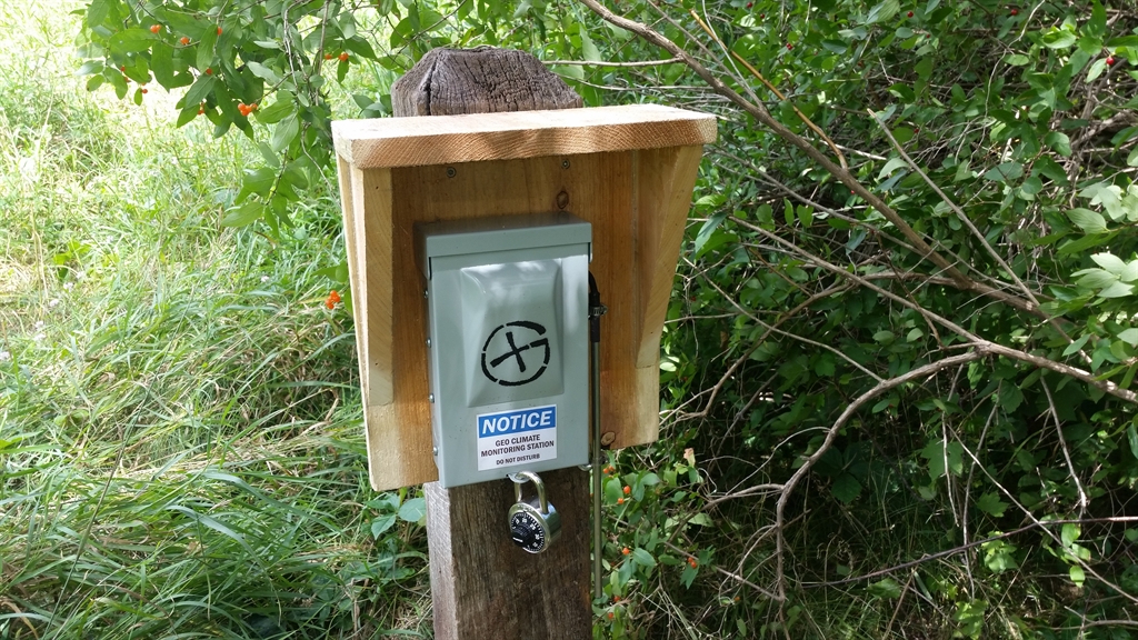 The geocache in the wild, attached, with permission, to a pole that was already there.