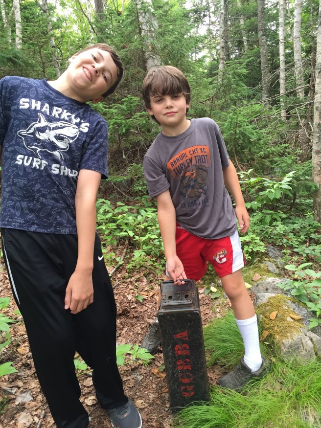 Says lpaulriddle: "My always-photogenic kids posing with GCBBA, Canada's oldest geocache."