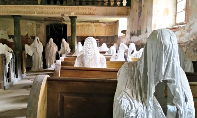 Over two dozen plaster figures are in the church