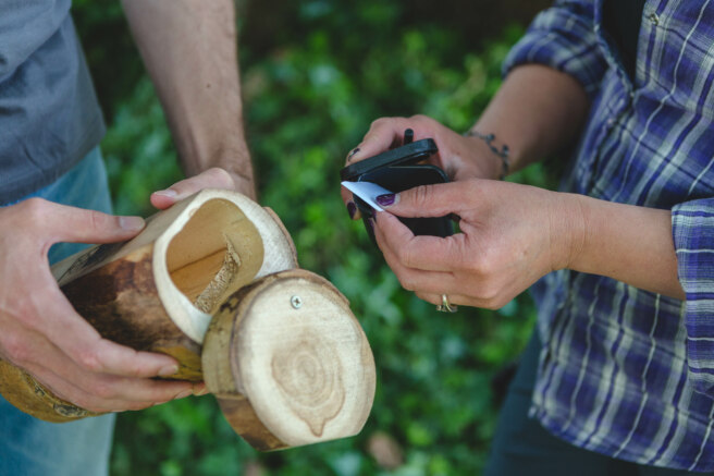 Hollowed out log container with paper log inside.